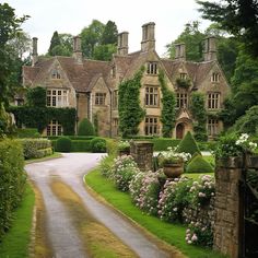 a large house with many windows and lots of greenery on the front lawns