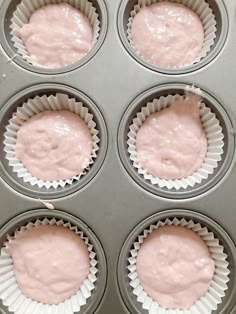 cupcakes with pink icing in a muffin tin