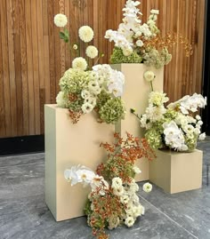 three vases filled with flowers on top of each other