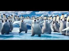 a group of penguins standing on top of snow covered ground