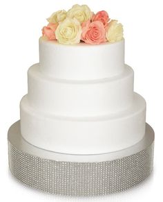 a white wedding cake with pink and yellow roses on top is displayed in the amazon app