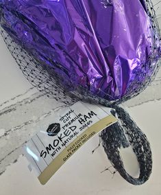 a close up of a bag of mardi gras beads and a string wrapped around it