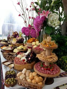 a table filled with lots of different types of food and flowers on top of it