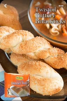 a plate with bread rolls and a bowl of soup