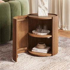 a corner table with a marble block on top and some glasses in the bottom shelf