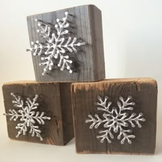 three wooden blocks with snowflakes on them