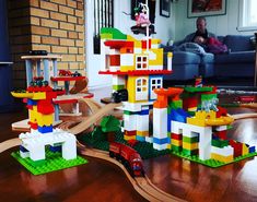 a child playing with legos on the floor in front of a couch and table