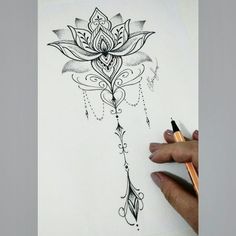 a drawing of a flower with beads hanging from it's center and leaves on the side