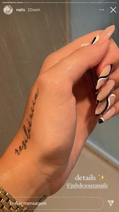 a woman's hand with a tattoo on it