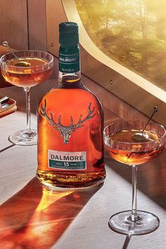 a bottle of dalmore next to two wine glasses