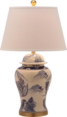 a blue and white vase with a lamp on it