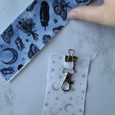 someone is holding onto a tie with scissors in front of it on a marble table