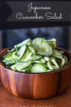 a wooden bowl filled with sliced cucumbers