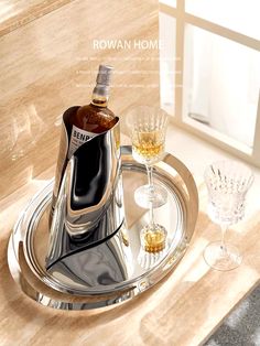 a bottle of liquor sitting on top of a silver tray