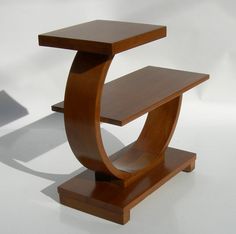 a wooden table with a shelf on it's side, against a white background