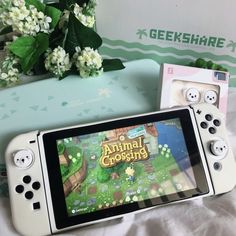 an animal crossing game is displayed on a nintendo wii console next to some other items