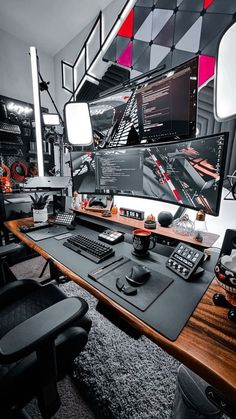 a computer desk with multiple monitors and keyboards