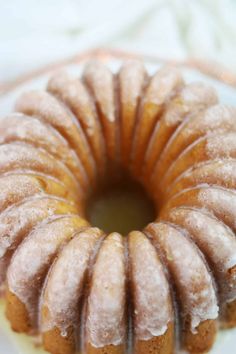 there is a bundt cake with icing on the top and bottom, sitting on a plate