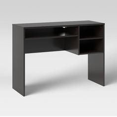 a black desk with an open shelf on top