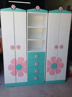 two white cabinets with pink and blue flowers painted on them