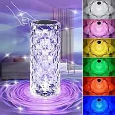 a glass vase sitting on top of a table next to different colors of lights in the background