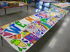 a long table covered in lots of different colored writing on it's sides and bottom