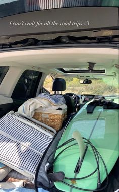 the back of a car with surfboards and luggage in the trunk, all packed up