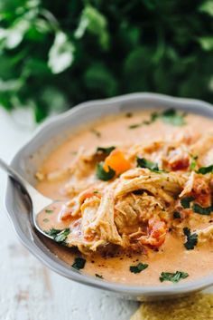 a white bowl filled with soup on top of a table