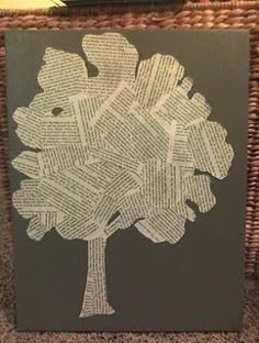 a tree made out of book pages sitting on top of a table