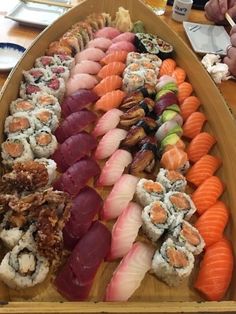 a platter filled with lots of different types of sushi