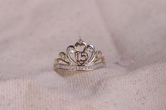 a tiara ring sitting on top of a white cloth