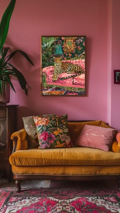 a living room with pink walls and an orange couch in front of a painting on the wall