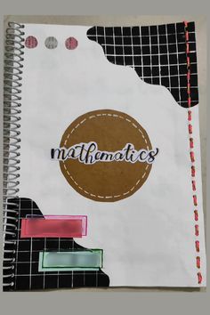 a spiral notebook with the word matmatics written on it, and an abstract background