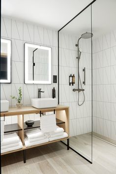 a bathroom with a sink, mirror and shower stall in it's own area