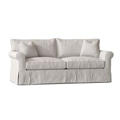 a white couch with two pillows on it