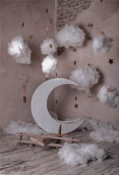 the moon is surrounded by clouds and stars in this room with wood flooring on the walls