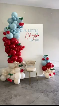 the balloon arch is decorated with cherries and balloons