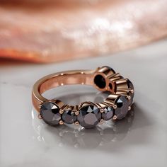 Multi Black Diamond Ring set with 4 Carats of Black diamonds! A Unique Wedding Ring 14k Rose Gold Black Round Diamonds Wedding Band. 🖤Setting Total Carat Weight: 4 Carats 14K Rose Gold Certificate Of Authenticity Included 🖤Main Diamond: Shape: Weight: Carats Color: Fancy Clarity: Color Origin: Enhanced Color Distribution: Even Grade: AAA Measurements: mm Stock ID: 🖤Accent Diamonds Shape: Round Weight: 4 Carats Color: Black Clarity: Opaque Color Origin: Enhanced Color Distribution: Even Grade: Rose Gold Rings With Black Diamonds For Anniversary, Black Diamond Band Ring, Gothic Wedding Ring, Black Diamond Band, Gothic Wedding Rings, Black Diamond Bands, Black Diamond Earrings Studs, Black Diamond Necklace, Black Diamond Studs