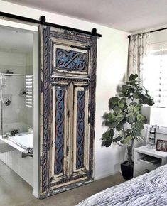 an old door is opened to reveal a bathroom with a bathtub in the background