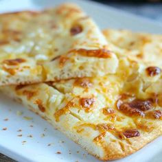 three pieces of cheese pizza on a white plate