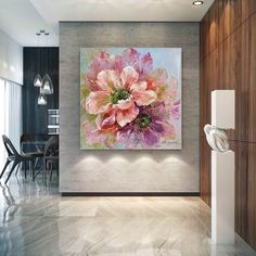 a large flower painting hanging on the wall