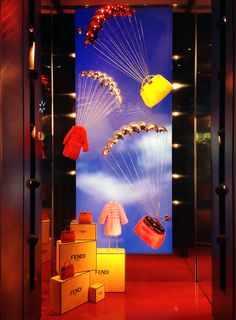 a display in a store with balloons, hats and sweaters