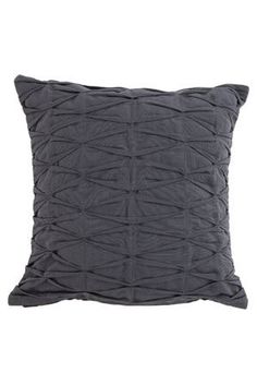 a gray pillow with pleated fabric on the front and back, sitting against a white background