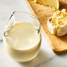 a close up of food on a cutting board with a glass of milk next to it