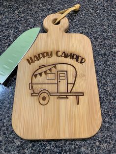 a wooden cutting board with a camper engraved on it