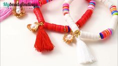 colorful bracelets with tassels and beads on a white surface, close up