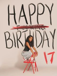 a woman sitting on top of a red chair in front of a happy birthday sign