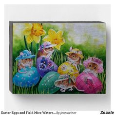 an easter card with three little mice in colorful eggs and daffodils on the grass