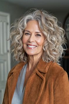 Dive into 8 fabulous long hairstyles created for the modern woman over 60, blending contemporary trends with classic beauty. Medium Length Curly Grey Hair, Greying Hair Highlights Blending, Layered Long Grey Hairstyles, Long Layered Grey Hair Over 50, Long Curly Hairstyles For Women Over 50, Mid Length Curly Grey Hair Over 50, Long Layered Curly Grey Hair, Long Hair Perm, Medium Length Curly Hair