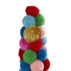 a stack of pom - poms on top of each other with a gold heart in the middle